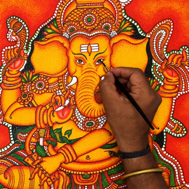 Painting the eye of the Ganesha with a fine brush