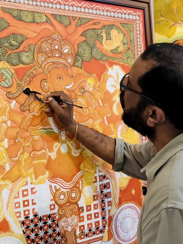 Dr. Saju Thuruthil painting a Kerala mural of Ganapathi